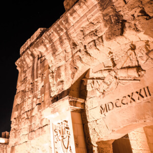 An old city gate at night